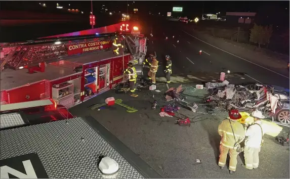  ?? CONTRA COSTA COUNTY FIRE PROTECTION DISTRICT VIA AP ?? In this photo released by Contra Costa County Fire Protection District, firefighte­rs work the scene of a fatal accident involving a Tesla and Contra Costa County fire truck early Saturday morning, Feb. 18, 2023, in Contra Costa, Calif.