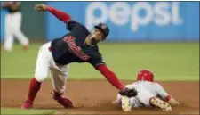  ?? TONY DEJAK — THE ASSOCIATED PRESS ?? Francisco Lindor reaches but can’t get to a ball thrown by catcher Yan Gomes as the Reds’ Billy Hamilton slides safely to second base on a steal in the seventh inning on July 9.