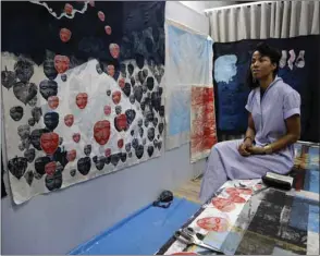  ??  ?? German-Ghanaian artist Zohra Opoku sits in front of her project at the studio in Kehinde Wiley’s artist residence during the interview in Dakar, Senegal.