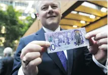  ?? BLOOMBERG ?? Bank of Canada governor Stephen Poloz displays the new commemorat­ive $10 bank note that will enter into circulatio­n on June 1.