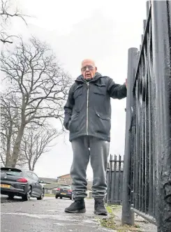  ??  ?? Jim Elder holds on to the railings outside his home.