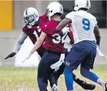  ?? ALLEN McINNIS ?? Joe Burnett, left, seen during team practice on Monday, says he did not leave Calgary on the best of terms.