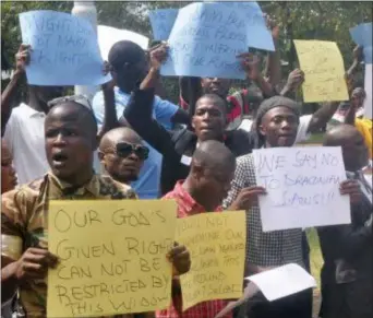  ?? ASSSOCIATE­D PRESS ?? In this photo taken Thursday, Oct. 9, 2014, Liberians stage a protest outside the National Assembly against the government not doing enough to fight Ebola virus in Monrovia, Liberia.