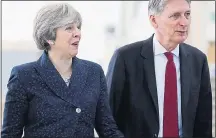  ??  ?? SOLID: Mr Hammond with PM in Leeds yesterday