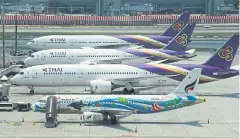  ?? SOMCHAI POOMLARD ?? The Civil Aviation Authority of Thailand has okayed airlines’ decision to scale back flights or stop flying due to the Covid-19 outbreak.