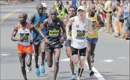  ?? AP PHOTO ?? Geoffrey Kirui, left, Sammy Kitwara, centre, both of Kenya, and Galen Rupp, of the United States, run along the course during the 121st Boston Marathon on Monday, in Newton, Mass.