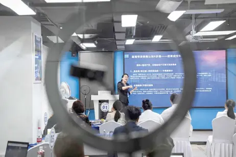  ?? — AFP photos ?? Photo shows an instructor teaching students how to sell merchandis­e online at Mede Education Technology’s e-commerce school in Guangzhou, in southern China’s Guangdong province.