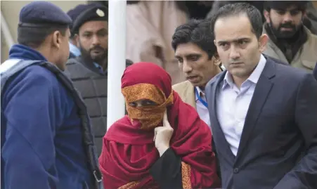  ??  ?? ISLAMABAD: The wife, center, of a judge is escorted from the Supreme Court by her brother in Islamabad, Pakistan, yesterday.—AP