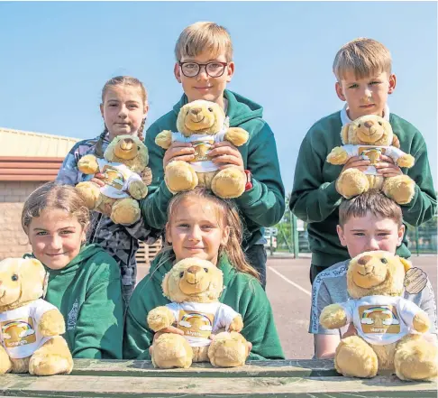  ??  ?? PAT ON THE BACK: Some of the P7 pupils with their own memory bear, front from left, Holleigh Dickie, Alysha White and Harry Duncan and back, Sahara Halfpenny, Dalin Keith and Lucas Burns, from Andover Primary School in Brechin. Pictures by Kim Cessford.