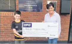  ?? ?? One of our U8 players presenting Karen O’Mahony from The Rainbow Club with a cheque for €500. This money was raised in our recent Glenville to Croke Park Challenge.