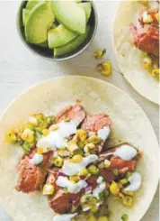  ?? Joe Keller, America's Test Kitchen ?? Flank steak tacos with charred corn salsa. This recipe appears in the cookbook “Cook It In Cast Iron.”