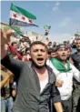  ?? CONTRIBUTE­D PHOTO BY MUSTAFA ALABDULLAH VIA AP ?? Protesters chant as they hold Syrian revolution flags, in Harim, a town in Idlib province, Syria, on Friday.