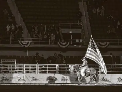  ?? Photos by Robin Jerstad / Contributo­r ?? A rider parades through Freeman Coliseum during the grand entrance to the San Antonio Stock Show and Rodeo’s opening night.