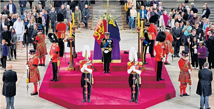  ?? ?? The King, the Princess Royal, the Duke of York and the Earl of Wessex hold a vigil beside the coffin of their mother, as it lies in state on the catafalque in Westminste­r Hall