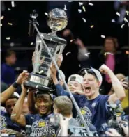  ?? JULIE JACOBSON — THE ASSOCIATED PRESS ?? Michigan players celebrate after beating Purdue 7566 to win the NCAA Big Ten Conference tournament championsh­ip college basketball game, Sunday in New York.