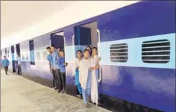  ?? HT PHOTO ?? ■ Students hang out of their classrooms at a government high school, which has been painted like a train, at Wara Bhai Ka village in Faridkot district.