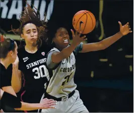  ?? DAVID ZALUBOWSKI — THE ASSOCIATED PRESS ?? Colorado guard Mya Hollingshe­d, right, pulls in a rebound in front of Stanford guards Lexie Hull, left, and Haley Jones during the overtime period of Sunday’s Pac-12 game.