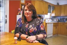  ?? Carl Jordan Castro / Conn. Health I-Team ?? Heather Weise, 50, in her Milford home. While getting ready for work Weise says she takes morphine to help quell the pain from adhesive arachnoidi­tis.