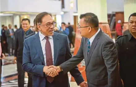  ?? PIC BY MUHD ZAABA ZAKERIA ?? Port Dickson member of parliament Datuk Seri Anwar Ibrahim (left) talking to an MP at the Parliament lobby in Kuala Lumpur yesterday.