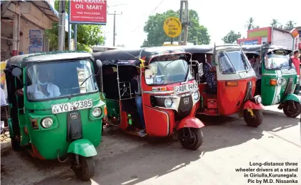  ??  ?? Long-distance three wheeler drivers at a stand in Giriulla,Kurunegala. Pic by M.D. Nissanka