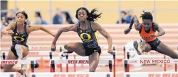  ??  ?? Oregon’s Sasha Wallace, center, won the women’s 60-meter hurdles over UTEP’s Tobi Amusan, right, by .001 of a second.