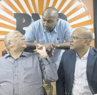  ?? FILE ?? From left: Dr Peter Phillips, Julian Robinson, and Peter Bunting in dialogue at a press briefing at the People’s National Party headquarte­rs in St Andrew last December.