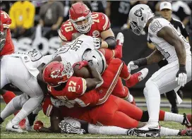  ?? AP ?? Chiefs seek 13th straight AFC West win Chiefs rookie Kareem Hunt (27) is stopped by the Raiders during Thursday’s game in Oakland. Subscriber­s can find the result from the late game in their ePaper.