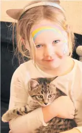  ?? ?? Four-year-old Darcie McNaught cuddles a kitten at New Shoots Early Learning Centre in Kerikeri.