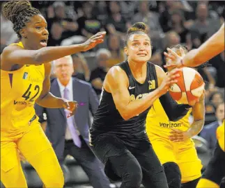  ?? Rachel Aston ?? Las Vegas Review-journal @rookie__rae Aces guard Kayla Mcbride (21) looks to shoot past Los Angeles Sparks center Jantel Lavender (42) and Lavender’s teammates in the second half Sunday at Mandalay Bay Events Center.