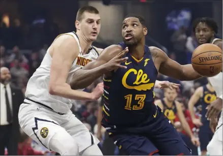  ?? TONY DEJAK — THE ASSOCIATED PRESS ?? Tristan Thompson, right, drives past the Nuggets’ Nikola Jokic on March 7at Rocket Mortgage FieldHouse.