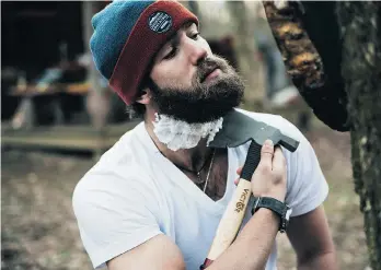  ?? KATHERINE WILLIAMS/THE CANADIAN PRESS ?? Toronto Blue Jays pitcher Daniel Norris shaves his beard with an axe in a staged shot for a modelling gig.