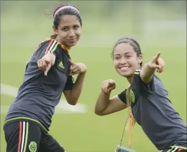  ?? SCOTT GARDNER, THE HAMILTON SPECTATOR ?? Two members of the Mexican women’s Pan Am soccer team ham it up for a teammate taking their photograph after a team practice in Burlington Tuesday.