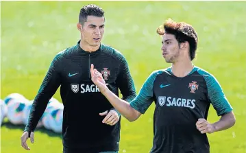  ?? AFP ?? Portugal forwards Cristiano Ronaldo, left, and Joao Felix attend a training session in Oeiras.