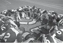  ?? MARK HENLE/ AZCENTRAL SPORTS ?? Flagstaff High baseball players gather around Evan Wissen’s No. 25 on Tuesday before the start of their state baseball playoff game against Marcos de Niza.