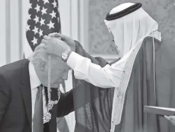  ??  ?? President Donald Trump receives the Order of Abdulaziz al-saud medal from Saudi Arabia’s King Salman at the Saudi Royal Court in Riyadh on Saturday. Mandel Ngan, Afp/getty Images