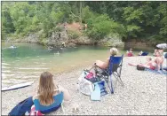  ??  ?? Come on in, the water’s fine at the McKissic Creek swimming hole in Bentonvill­e. Swimming holes along the Ozark’s streams offer cool relief from the summer heat, along with gravel beaches perfect for a picnic or just relaxing.