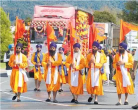  ?? ?? The five Nishanchis, with flags, ahead of the five Panj Piare at the last Te Puke Sikh Parade in 2019.