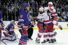  ?? Mike Stobe/ Getty Images ?? Joel Ward of the Washington Capitals is mobbed by teammates after scoring the game winner on Thursday.