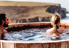  ??  ?? Romance: The Jacobean-style Lewtrencha­rd Manor in Devon, top. Above, sea-view outdoor hot tub at The Scarlet in Cornwall