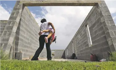  ?? AP FILE PHOTO ?? A woman in Sullivan City, Texas, who is in the country illegally, plays in 2015 with her 2-year-old daughter who was born in the United States but was denied a birth certificat­e. Citizenshi­p is guaranteed to those born in the United States by the 14th Amendment, but Trump vows he will undo it with an executive order.