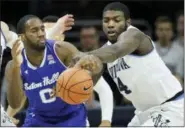  ?? AP PHOTO/LAURENCE KESTERSON ?? Villanova forward Eric Paschall (4) gets the ball away from Seton Hall guard Khadeen Carrington (0) during the second half of Sunday’s game in Philadelph­ia.