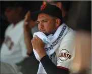  ??  ?? Giants starting pitcher Tyler Beede sits on the bench and reflects after getting pulled in the fifth inning against the A’s.