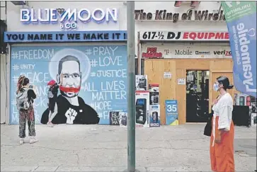  ?? Photograph­s by Gary Coronado Los Angeles Times ?? A PORTRAIT of George Floyd was painted over plywood at Blue Moon & Co., a jewelry shop on South Broadway in downtown Los Angeles, on the second day of protests over his death, a nearby merchant says.