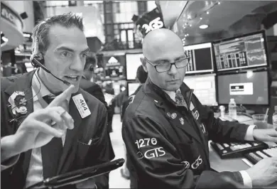  ?? REUTERS ?? Traders work on the floor of the New York Stock Exchange shortly after the opening bell in New York, US, on Tuesday. The US tax cuts are expected to further fuel the US equity market, but may not be a blessing for overseas stock markets.