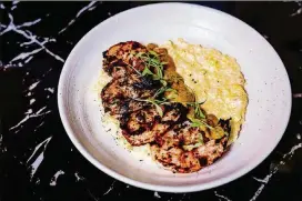  ?? PHOTOS CONTRIBUTE­D BY HENRI HOLLIS ?? What’s so special about suya shrimp and grits at Rock Steady? The flavor of a smoky peanut-based spice blend from Nigeria.