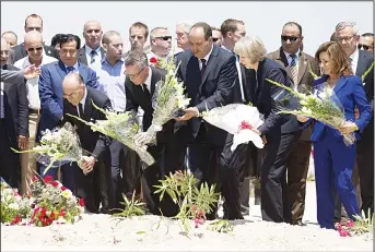  ??  ?? (Left to right bottom): French Interior Minister Bernard Cazeneuve, German Interior Minister Thomas de Maiziere, Tunisian Interior Minister Mohamed Najem Gharsalli and British Home Secretary Theresa May lay flowers on the site of a shooting attack on...