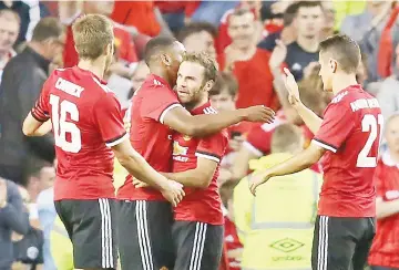  ?? - AFP photo ?? Manchester United’s Spanish midfielder Juan Mata (2R) celebrates with teammates scoring the second goal during the pre-season friendly game between Manchester United and Sampdoria at the Aviva stadium in Dublin.