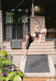  ?? JEENAH MOON/THE WASHINGTON POST ?? Aerialist and opera singer Marcy Richardson practices her aerial hoop act in her Brooklyn backyard.