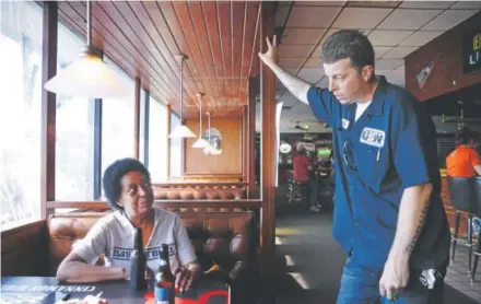  ?? Chris Bergin, The Washington Post ?? Former Carrier employee Brenda Battle and T.J. Bray, who still works at the manufactur­er, visit at Sully's Sports Bar & Grill in Indianapol­is. Battle accepted a buyout from Carrier after working at the company for 25 years.