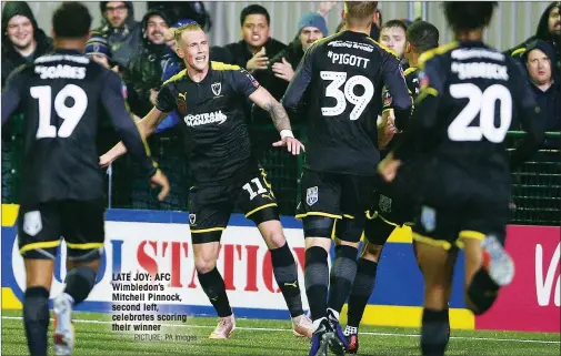  ?? PICTURE: PA Images ?? LATE JOY: AFC Wimbledon’s Mitchell Pinnock, second left, celebrates scoring their winner